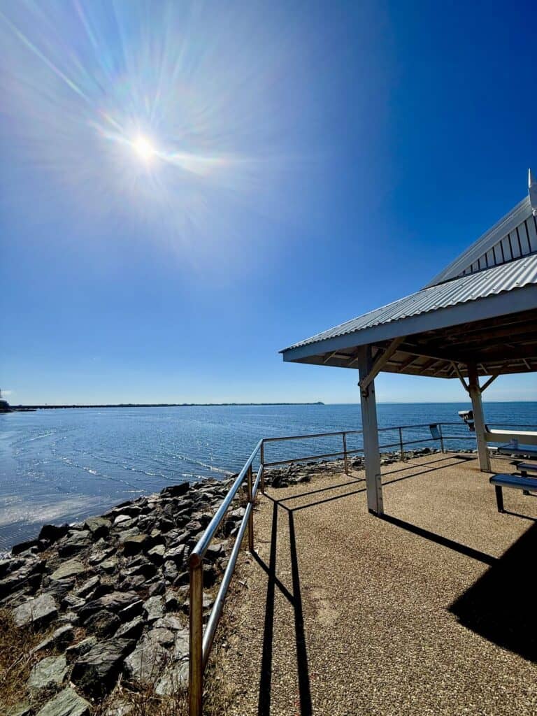 Sunny day on the Brighton foreshore looking across Moreton Bay towards the Redcliffe Peninsula