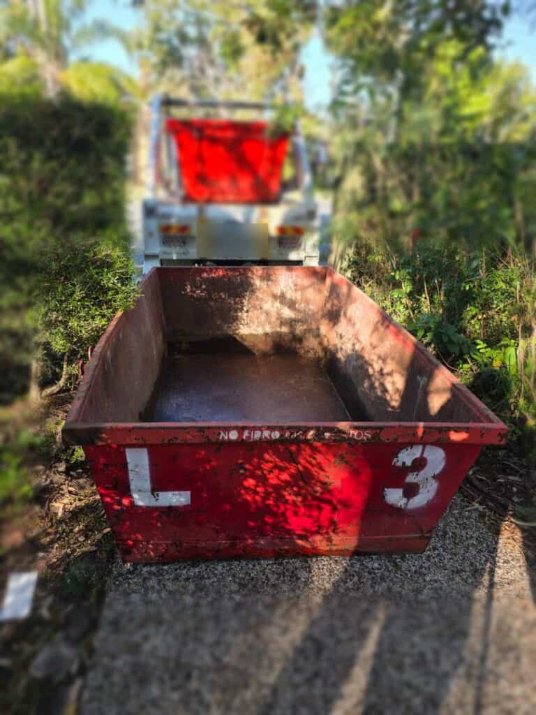 A 3m³ low side Redcliffe Skips bin delivered beside the garden in Deception Bay