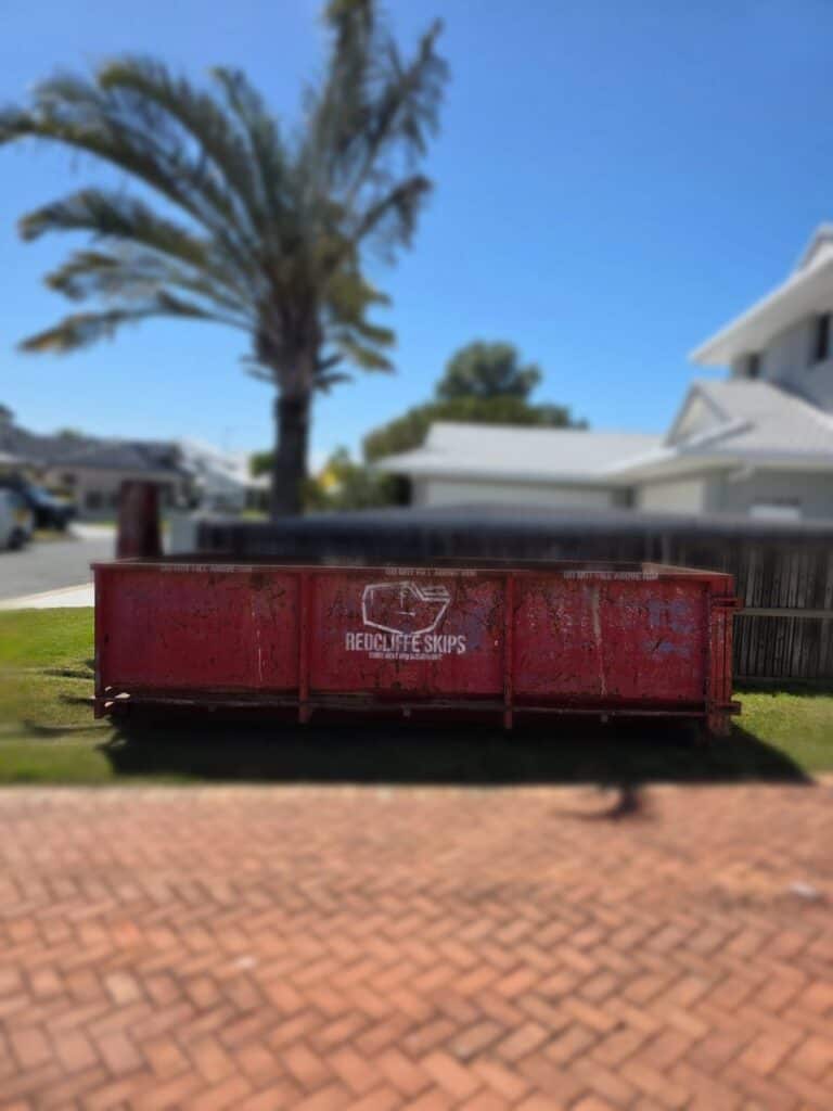 A 10m³ Redcliffe Skips bin dropped on the grass in Newport, next door to Scarborough